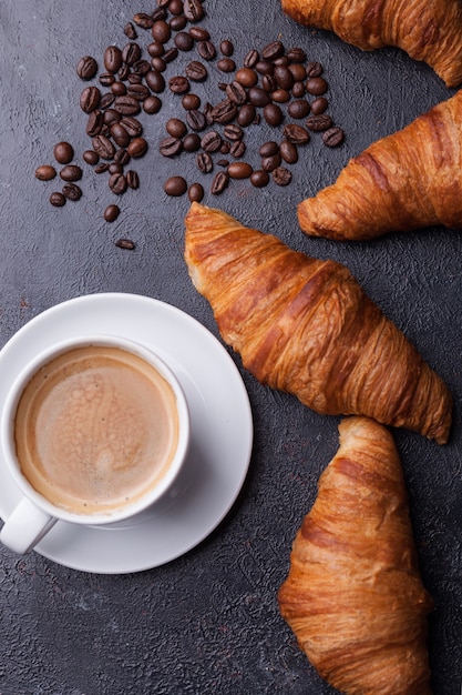 Free Photo top view of coffee and croissant with coffee beans. delicous coffee.