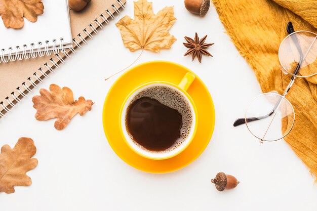 Top view of coffee cup with glasses and autumn leaves