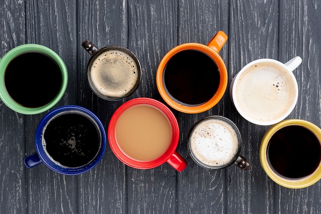 Top view of coffee cups on wooden table