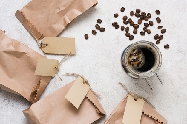 Free photo top view coffee and paper bags with labels