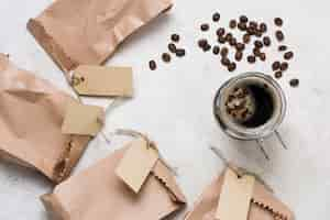 Free photo top view coffee and paper bags with labels