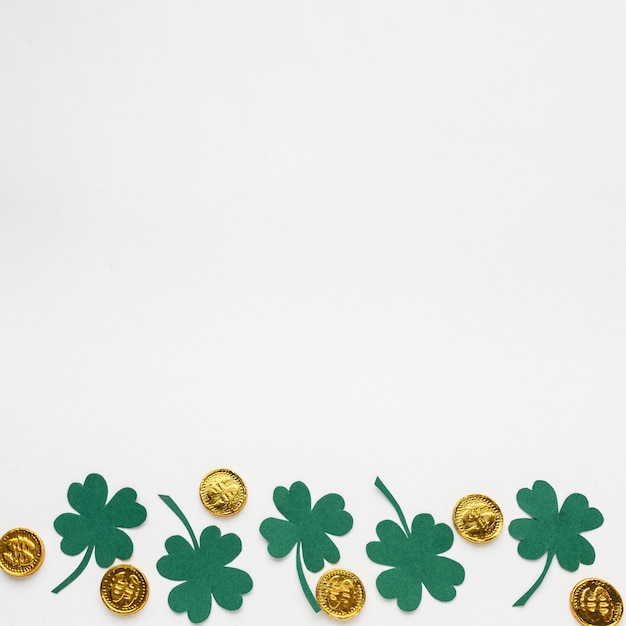 Free Photo top view coins and clovers frame