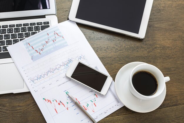 Top view of colorful business report next to a cup of coffee