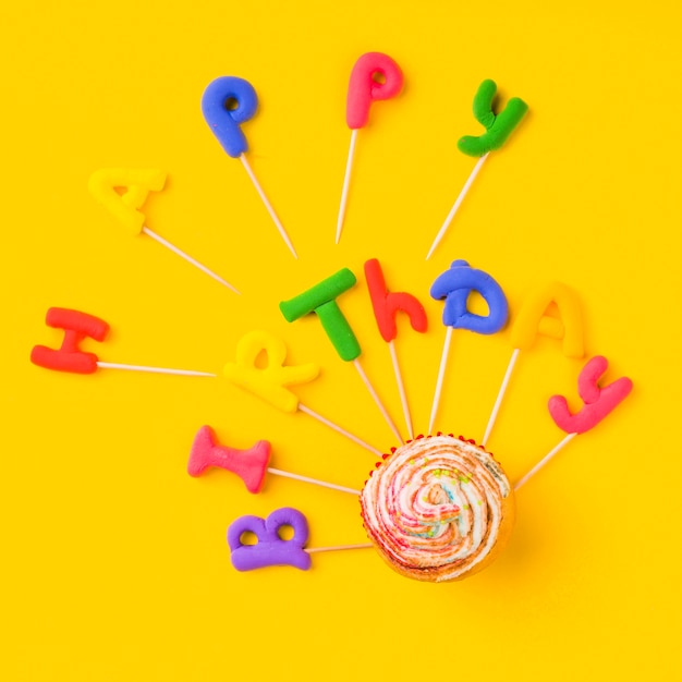 Free photo top view colorful clay words with cupcakes