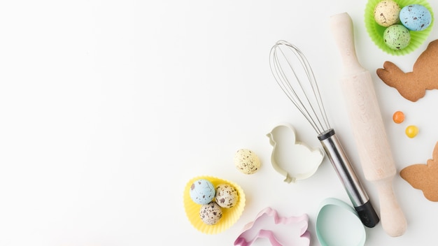 Top view of colorful eggs and kitchen utensils with copy space