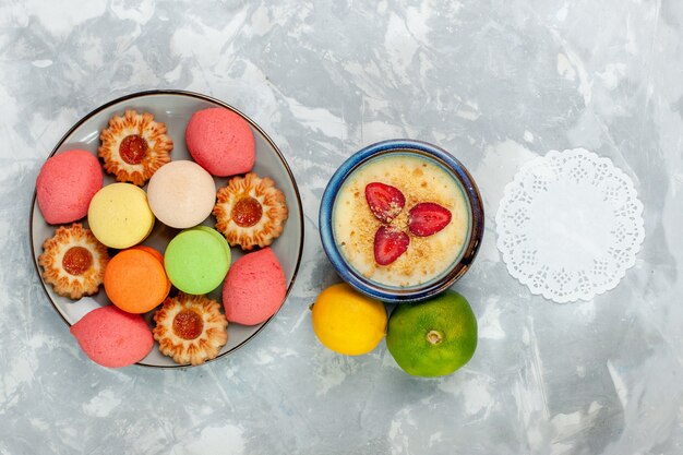 Top view colorful french macarons delicious cakes with cookies and dessert on white desk bake cake sweet sugar dessert biscuit