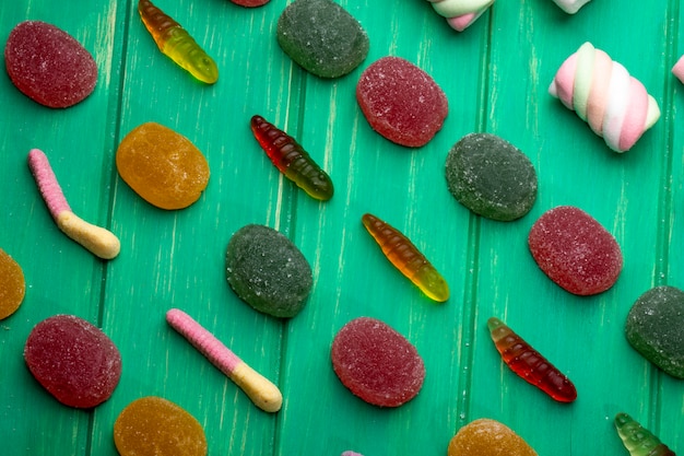 Free Photo top view of colorful marmalade jelly candies on green wood