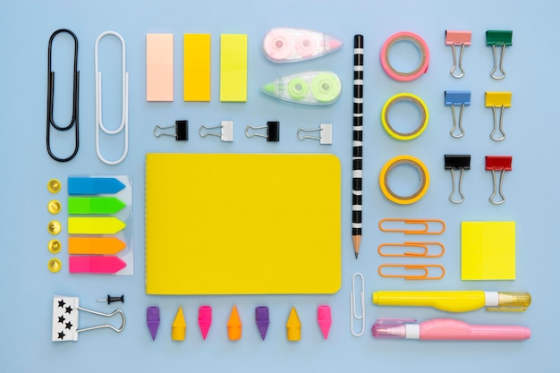 Free photo top view of colorful office stationery with paper clips and erasers