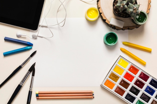 Top view of colorful paint on desk concept