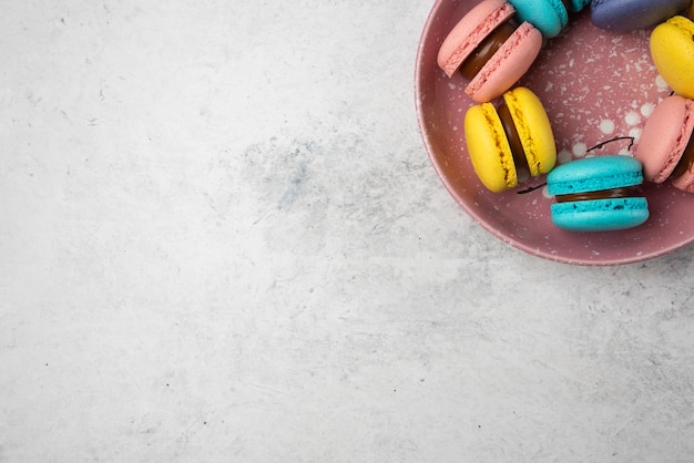 Top view of colorful pastel macarons on white background. 