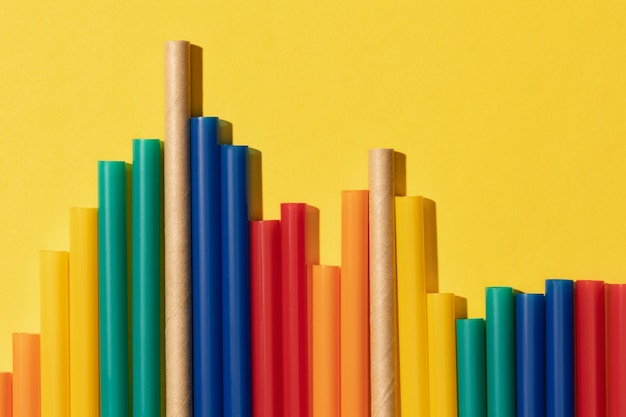 Top view of colorful plastic straws mixed with paper ones