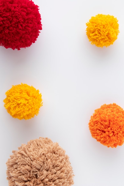 Free photo top view colorful pom poms arrangement