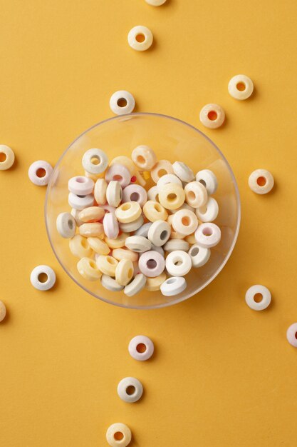 Top view of colorful round candy in transparent bowl