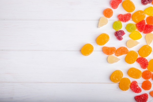 Top view of colorful tasty marmalade candies scattered on rustic