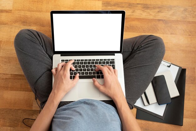 Top view of comfortable man in quarantine at home using laptop for work