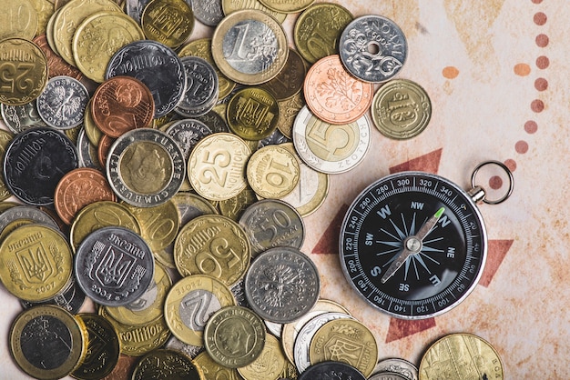 Free Photo top view of compass and coins