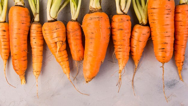 Top view composition of carrots with copy space