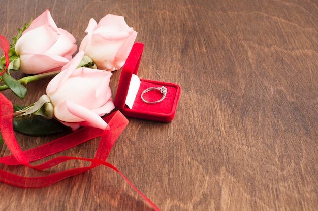 Free photo top view composition with roses and engagement ring