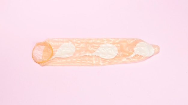 Free Photo top view condom with spermatozoa inside