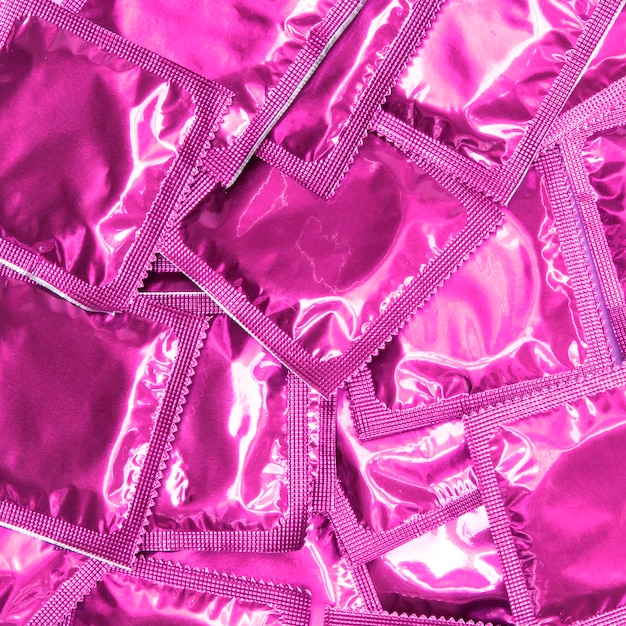 Top view condoms in pink wrappers