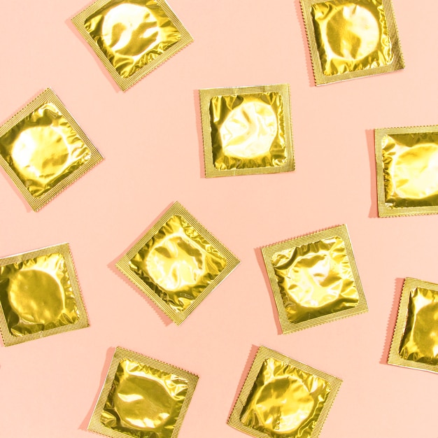 Free photo top view condoms with golden wrappers