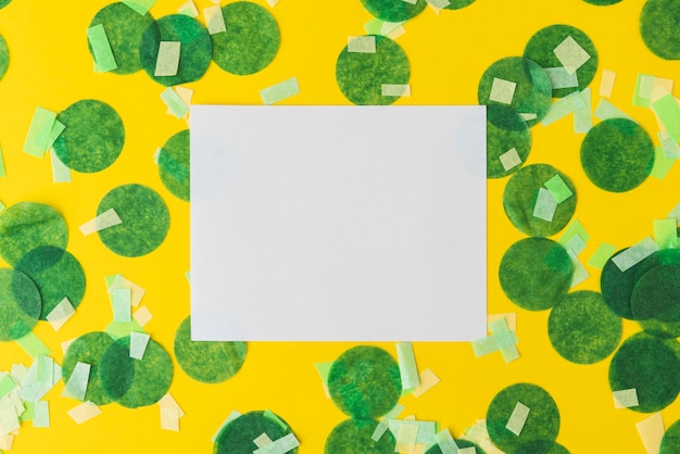 Free photo top view of confetti frame on yellow background with copy space