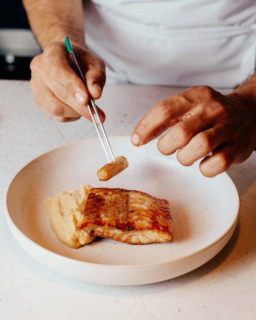 A top view cook preparing meal inside white plate and in kitchen food meal dinner cuisine