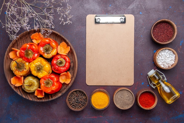 Free Photo top view cooked bell-peppers with ground meat and different seasonings on dark surface meat vegetables beef meal