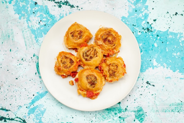 Top view of cooked dough meal with minced meat inside plate on bright desk, dough meal food meat