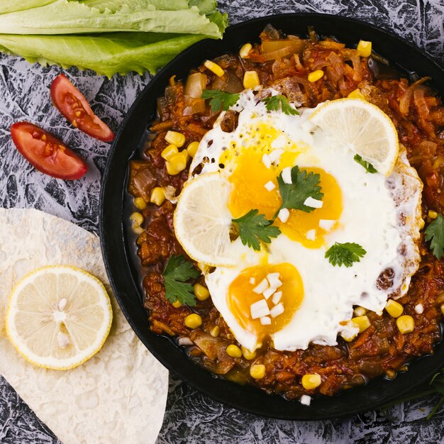 Top view cooked eggs on mexican dish