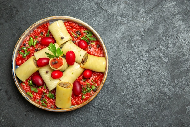 Top view cooked italian pasta delicious meal with meat and tomato sauce on a grey background pasta dough meat sauce food