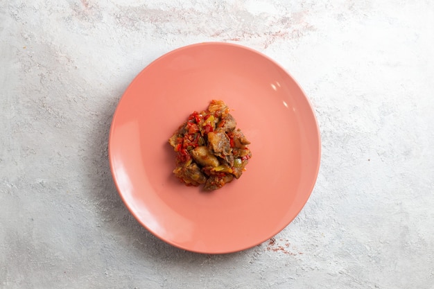 Top view cooked little meat pieces inside plate on white surface