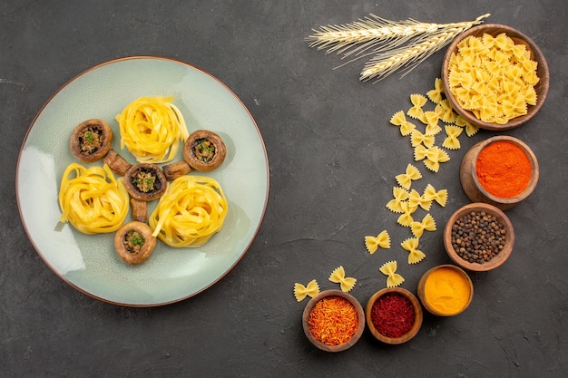 Top view cooked mushrooms meal with seasonings on a dark table meal fry food dinner