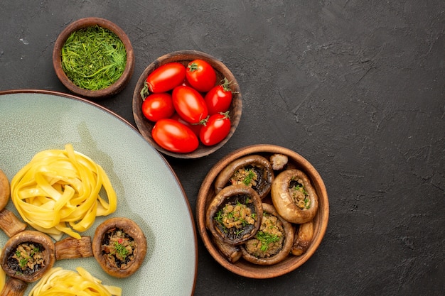 Top view cooked mushrooms with dough pasta on dark table food dinner meal color