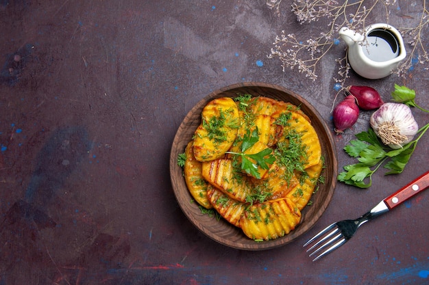 Top view cooked potatoes delicious dish with greens on dark surface cooking meal dish potato dinner