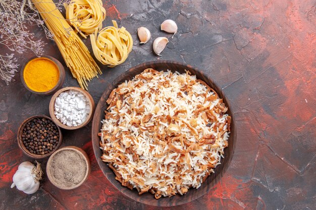 Free Photo top view cooked rice along with seasonings on dark floor food dish photo meal