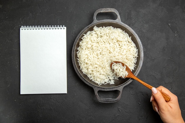 Free Photo top view cooked rice inside pan on a dark surface meal food rice eastern dinner