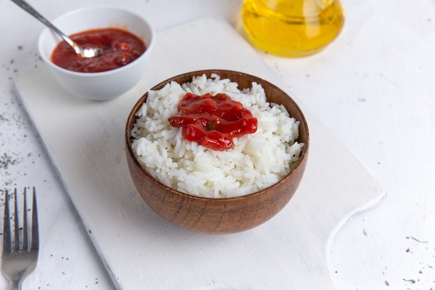 Free Photo top view of cooked rice tasty meal inside brown pot with spicy sauce on the white floor rice food meal dish dinner