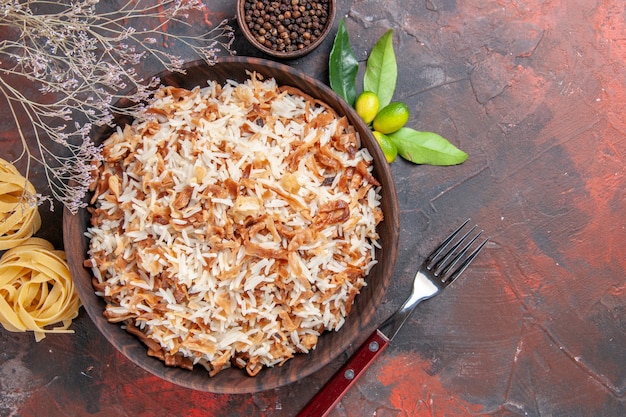 Free photo top view cooked rice with dough slices on dark surface food dish dark photo meal