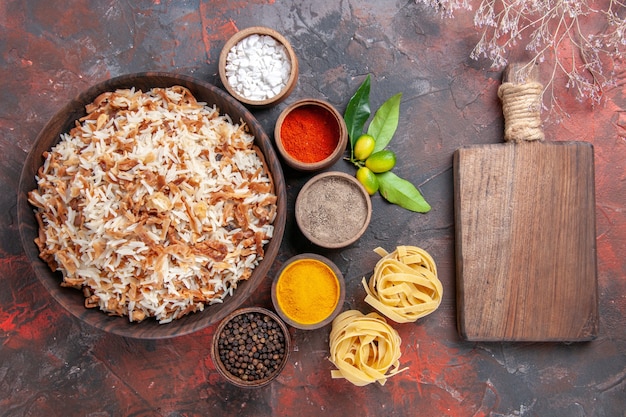 Top view cooked rice with seasonings on dark desk food dish dark meal photo