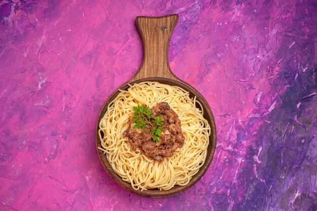 Top view cooked spaghetti with ground meat on pink floor pasta seasoning dough dish