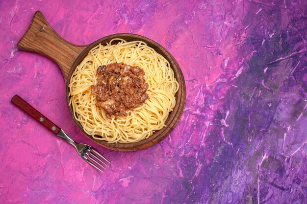 Top view cooked spaghetti with ground meat on pink table pasta dough dish seasoning