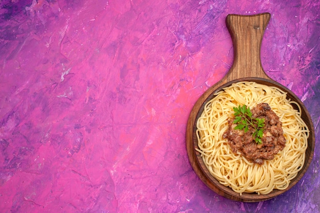 Top view cooked spaghetti with ground meat on pink table pasta seasonings dough dish