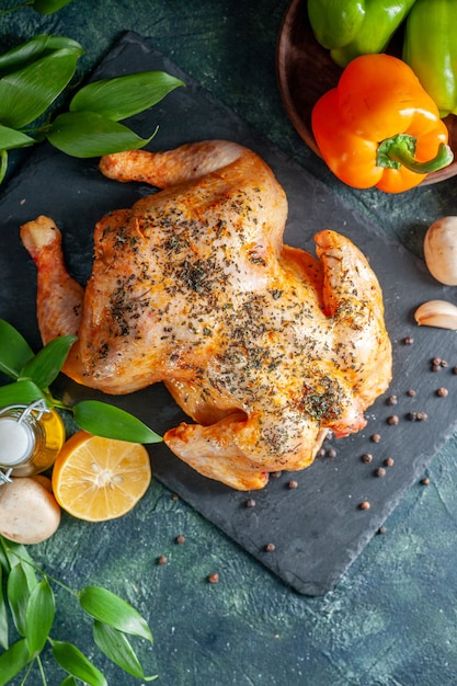 Top view cooked spiced chicken with wine and garlic on dark surface