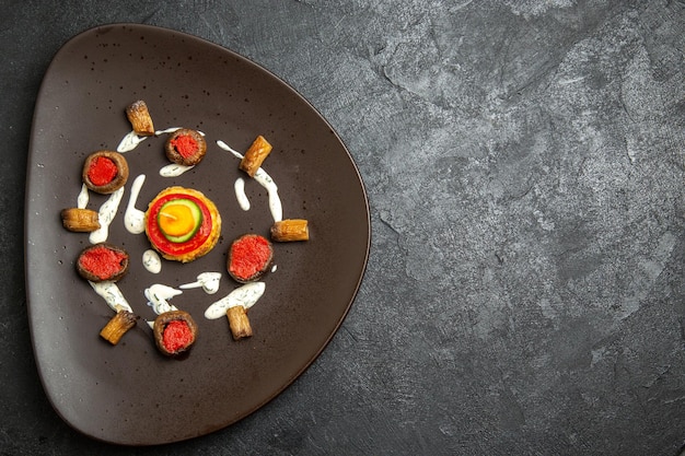 Top view of cooked squashes designed meal inside plate on a grey surface