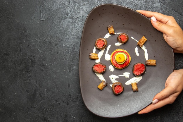 Top view of cooked squashes designed meal inside plate on the grey surface