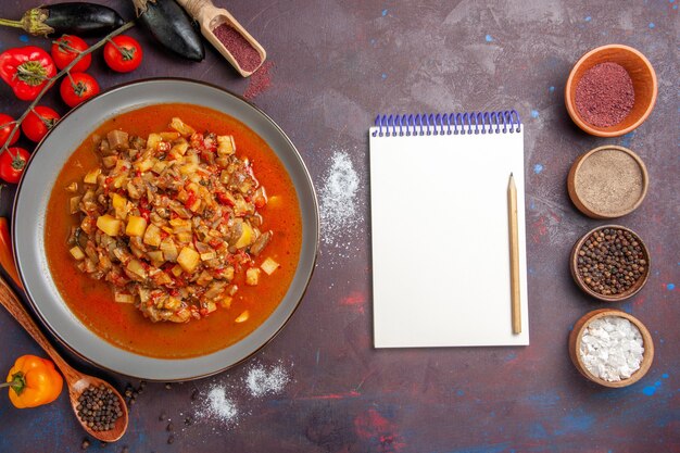 Free photo top view cooked vegetables sliced with sauce and seasonings on dark floor meal food dinner soup sauce vegetable