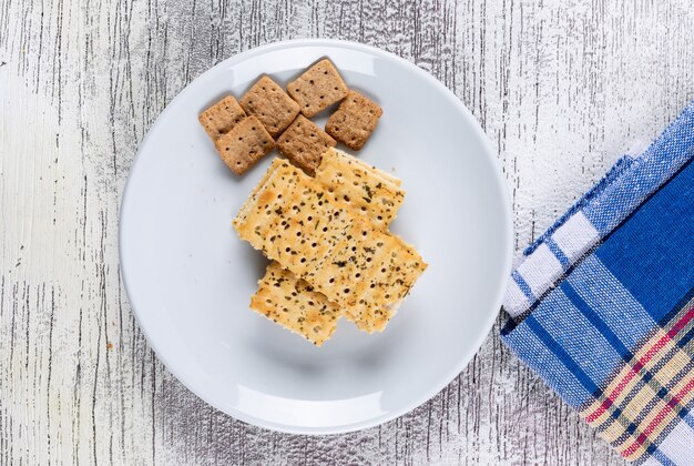 Top view cookies on plate and cloth on white wooden  horizontal