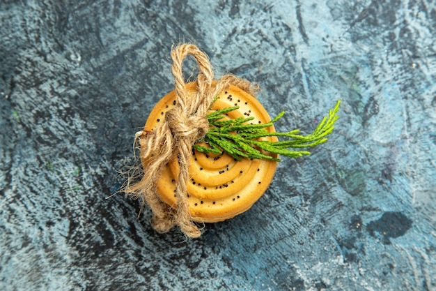 Top view cookies tied with a rope on grey surface with copy space