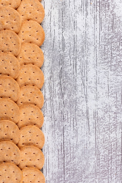 Free Photo top view cookies with copy space on white wooden  vertical